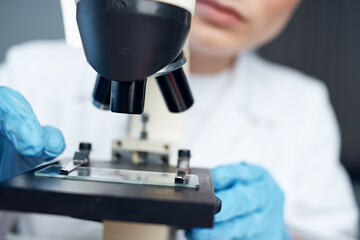 woman laboratory assistant microscope setting research microbiology