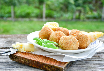 Italian arancini Cacio e pepe. Home-made rice balls with mozzarella cheese, parsley, lemon, and parmesan cheese.