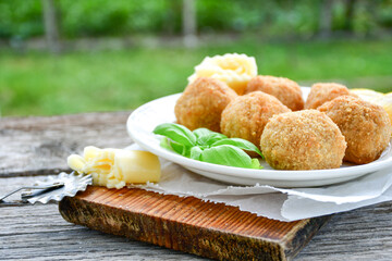 Italian arancini Cacio e pepe. Home-made rice balls with mozzarella cheese, parsley, lemon, and parmesan cheese.