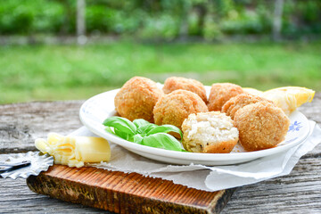 Italian arancini Cacio e pepe. Home made rice balls with mozzarella cheese ,parsley ,lemon and parmesan cheese.