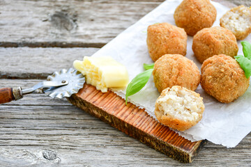 Italian arancini Cacio e pepe. Home-made rice balls with mozzarella cheese, parsley, lemon, and parmesan cheese.