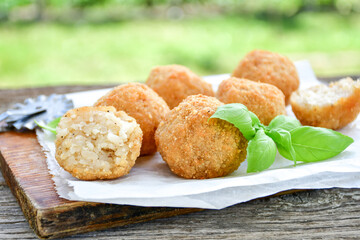 Italian arancini Cacio e pepe. Home-made rice balls with mozzarella cheese, parsley, lemon, and parmesan cheese.