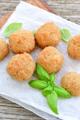 Italian arancini Cacio e pepe. Home-made rice balls with mozzarella cheese, parsley, lemon, and parmesan cheese.