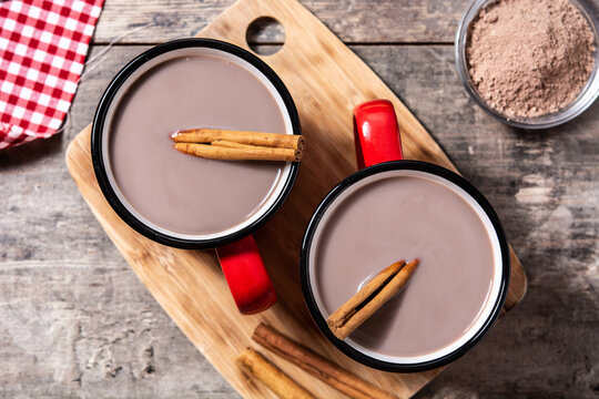 Traditional Mexican chocolate atole drink on wooden table. Top view