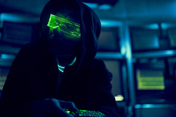 Cyber hacker breaks into databases to obtain information using a computer.
