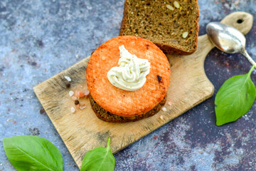 Homemade ketogenic  Salmon Burger with Tartar Sauce and  whole grain ketgenic bread. Healty food