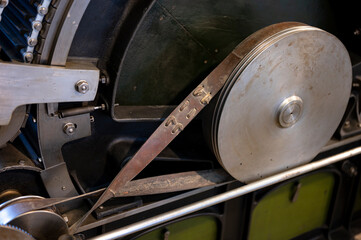 Detail of an old leather stitched and crossed pulley