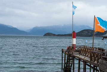 USHUAIA, ARGENTINA - april 04. 2018: Ships at the Port of Ushuaia, the capital of Tierra del Fuego, next to the little harbor town. Ushuaia is the southernmost city in the world