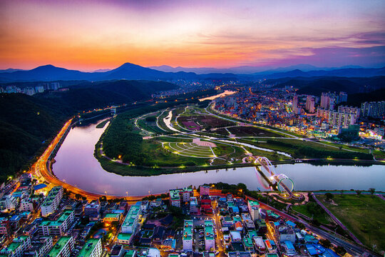 Aerial shot of cityscape and a beautiful river at sunset in Ulsan, South Korea