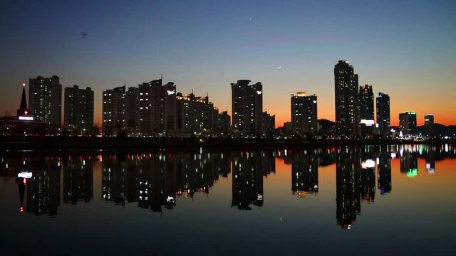 A panorama of skyscrapers and their reflection on the river at sunset, Ulsan, South Korea