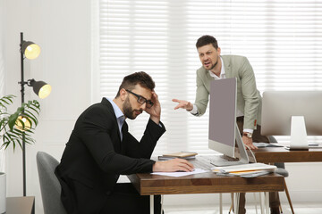 Boss screaming at employee in office. Toxic work environment