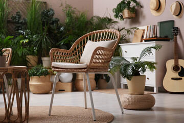 Room interior with stylish furniture and different houseplants