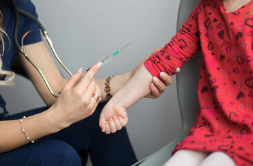 Doctor vaccinating child little girl at hospital.
