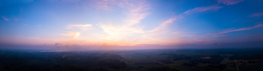 Fototapeta na wymiar Foggy sunset over the fields in the countryside