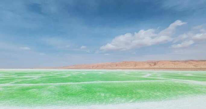 time lapse of the green salt lake landscape, the jade lake against a blue sky in Mangya, Haixi Mongolian and Tibetan Autonomous Prefecture,Qinghai province, China.