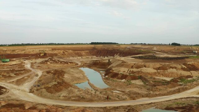 Drone flying over open pit mine, quarry. Open pit for gold mining. Aerial of of opencast mining quarry. Giant quarry with minerals extraction. Large industrial sand quarry.