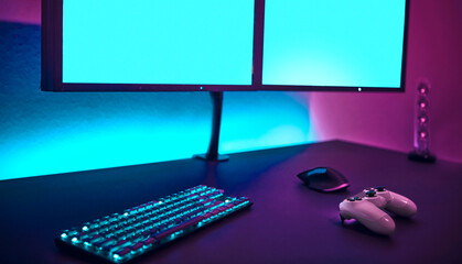 Male player using computer keyboard and mouse. Blank monitor to insert your content.