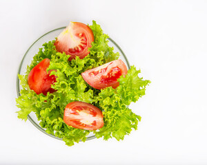 Salad with fresh tomatoes and lettuce on the white background