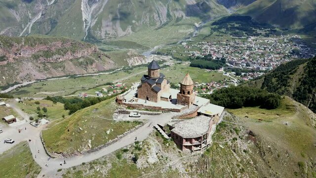 Aerial Drone Shot of Gergeti Trinity Monastery Kazbegi Georgia with Beautiful Mountains