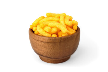 Cheese flavored puffed corn snacks in wooden bowl isolated on white background.