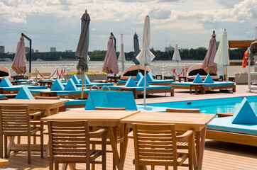 blue pool area. Tourist vacation by the water with a restaurant area and a bed for relaxation