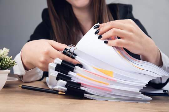 Woman Holding Stack Of Business Documents