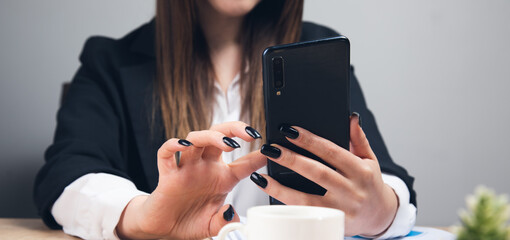 woman hands using phone in office