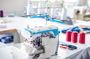Interior of garment factory . Closes making atelier with several sewing machines. Tailoring industry, fashion designer workshop, industry concept