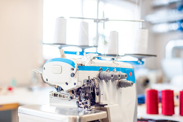 Interior of garment factory . Closes making atelier with several sewing machines. Tailoring industry, fashion designer workshop, industry concept