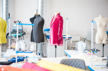 Interior of garment factory . Closes making atelier with several sewing machines. Tailoring industry, fashion designer workshop, industry concept
