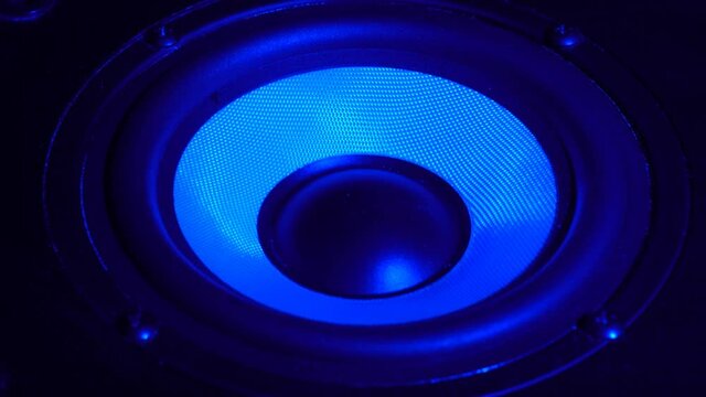 This stock video shows a close-up shot of a speaker playing loud music in a nightclub.