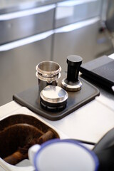 Coffee tamper view from a barista desk. Coffee concep