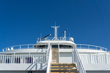 Naklejka premium Modern Ferry Ship Deck Control and Exterior against Blue Sky. Marine Traffic. 