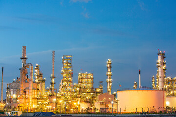 Fototapeta na wymiar Twilight scene of oil refinery plant and storage white tank oil of Petrochemistry