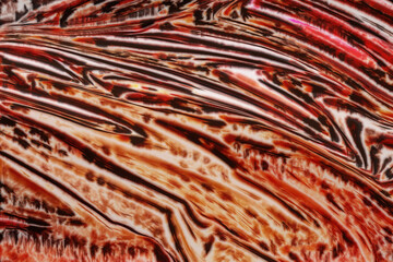 A beautiful abstraction with red and orange streams. Texture with white and black lines. Hot lava flows.