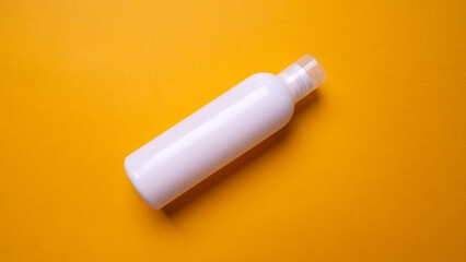 packaging of face cream or mousse on yellow background