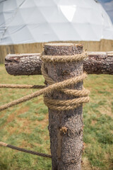 Fototapeta premium Rope tying fence logs close-up