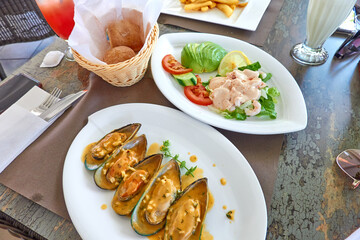 Restaurant food - shrimps, mussel and sliced avocado.