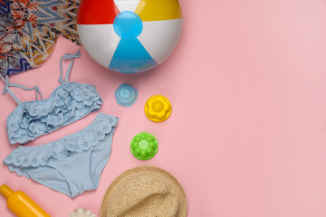 Flat lay composition with beach ball on pink background. Space for text