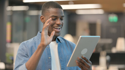 Video Call on Tablet by Young African Man 