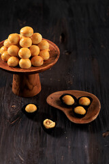 Nastar Cookies, Pineapple Tarts or Nanas Tart are Small, Bite Size Pastries Filled Pineapple Jam. Popular as Kue Kering Lebaran. Served on Cake Stand, Dark Background