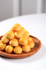 A Pile of Nastar or Ananas Taartjes or Pineapple Tart, Most Popular Various of Kue Kering Lebaran, Usually Served During Hari Raya. Wooden Background with Negative Space.