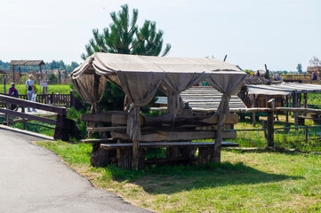 Fototapeta na wymiar Handmade wooden vintage bench in a summer park. 15 August 2021, Baranovichi, Belarus