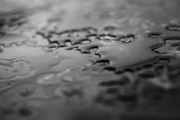 Black and white photo of water drop surface on black marble.