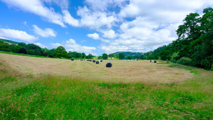 Straw bales in a field on the banks of the river Usk at Llandetty near Tay-y-bont, Wales