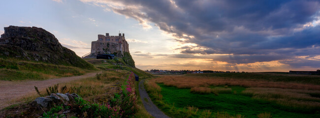 Summer evening and sunset views of Lindisfarne Castle on Holy Island, Northumberland, UK