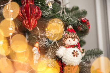 Christmas background with tree and balls, garland in defocus. New year card and copy space.