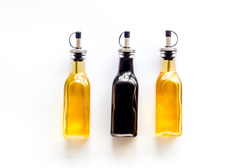 Balsamic and apple cider vinegar in glass bottles top view