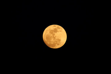Obraz premium Golden full moon of March 2014 against dark blue sky from La Savina (Formentera, Balearic Islands, Spain)