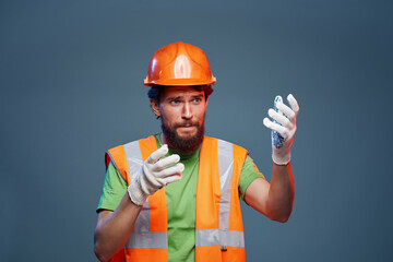 bearded man orange helmet on the head professional emotions